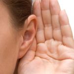 Photo of a hand held up to an ear to indicate listening