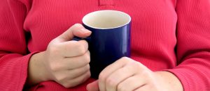 hands holding mug of tea