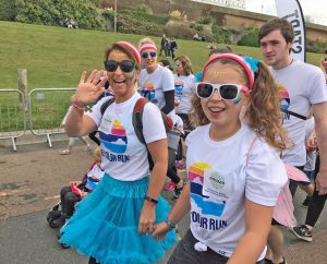 Colourfully dressed mum and girl in Color Run for Amaze