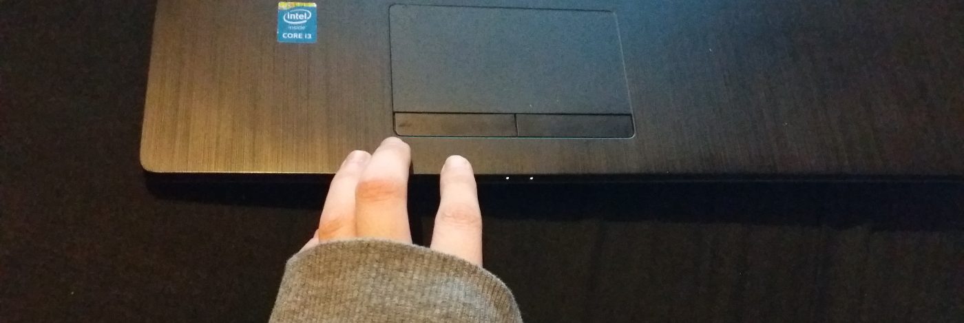 fingers resting on edge of laptop