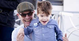 smiling dad and young son with compass card in top pocket