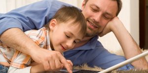 dad searching on computer with son