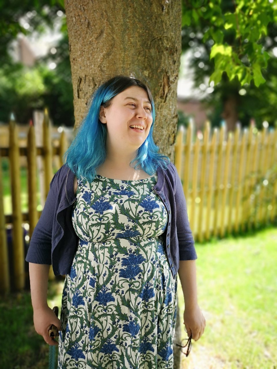 smiling young woman with blue hair