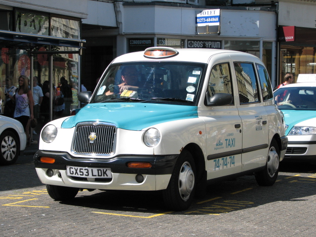 White and aqua Brighton taxi