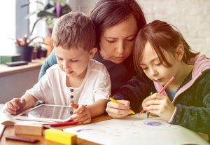 Mum and kids at homeschool learning together