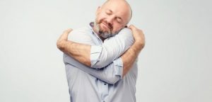 man hugging himself