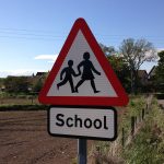 traffic sign saying "school" with image of children