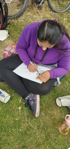 young woman drawing outdoors