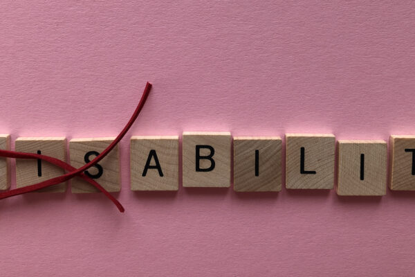 Scrabble letters spell out disability with Dis covered in string