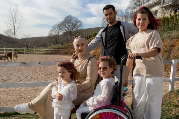 Girl in wheelchair with her family