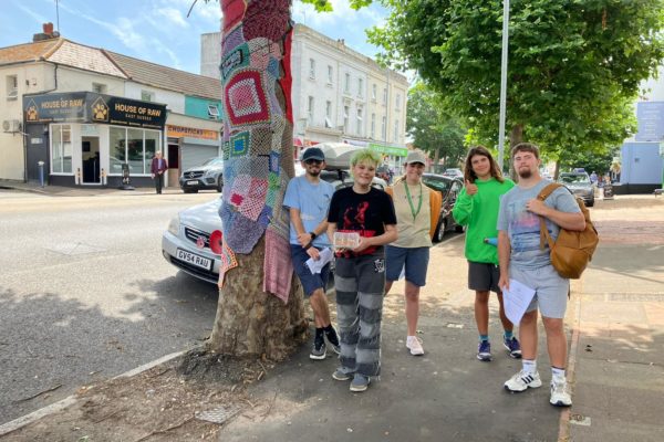 Small group of young people walking down the street.
